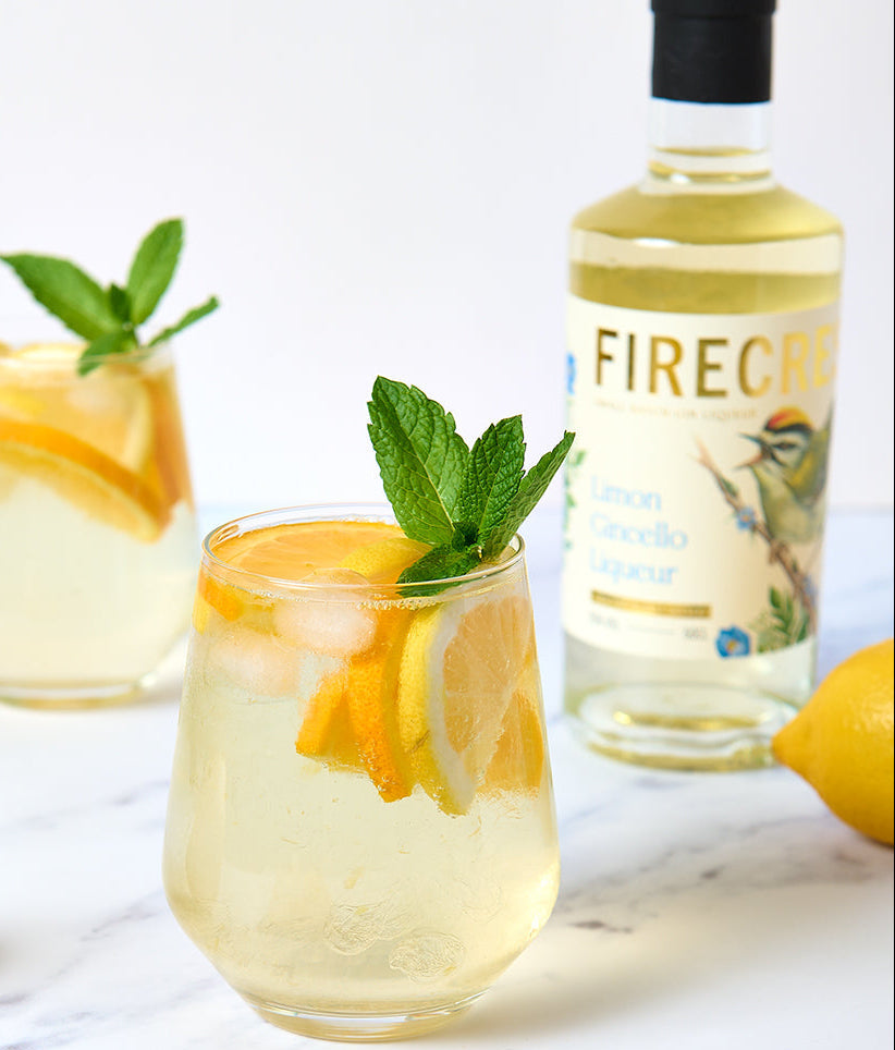 Two glasses of citrus spritz cocktail with Firecrest Limon Gincello 